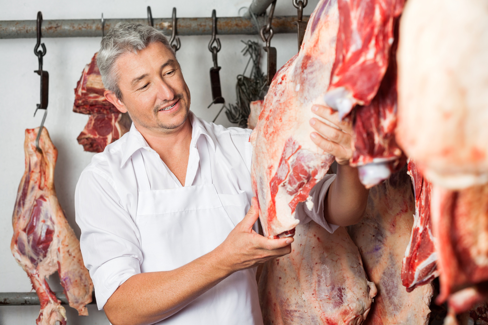 Butcher Checking Quality Of Meat In Butchery